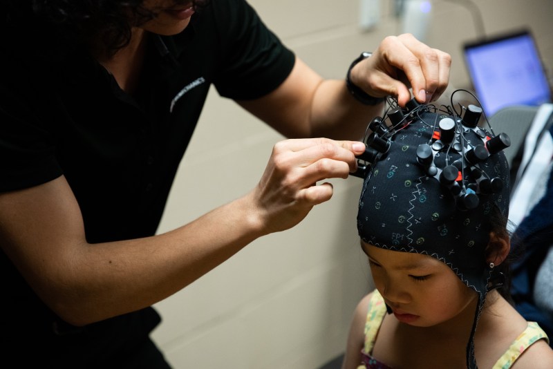 Jorge Zuniga and his team measure the brain waves of a child using a 3D printed prosthetic arm