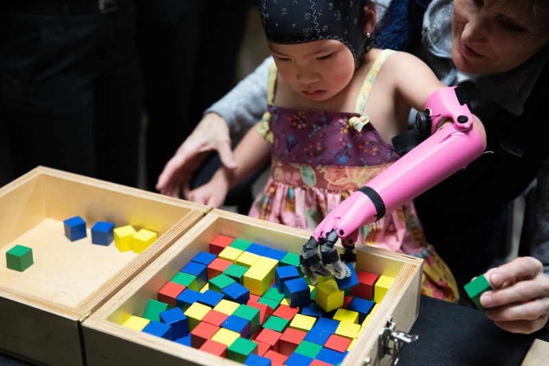 A child uses a 3D printed arm during a study to measure brain function while using prosthetics with Jorge Zuniga's research team
