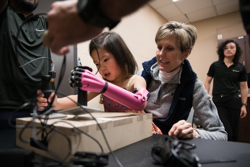 A child participates in a study to learn how 3D printed prosthetics use affects the brain in a limb different child.