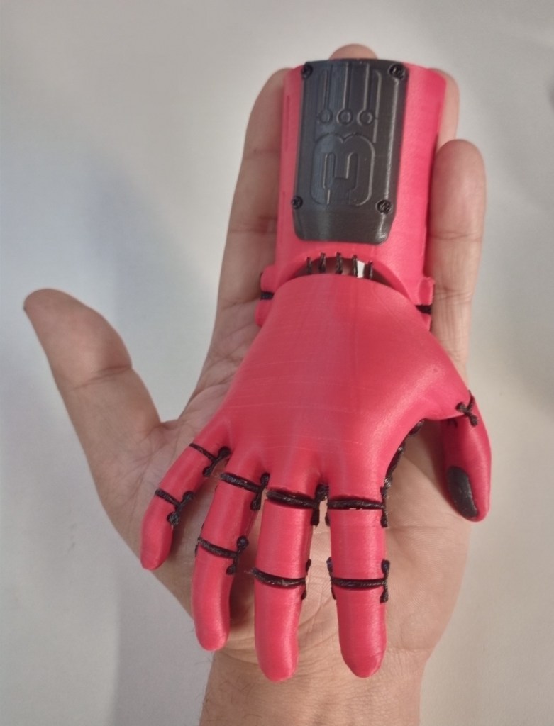 "The Kinetic Hand sized for a child in pink plastic"
