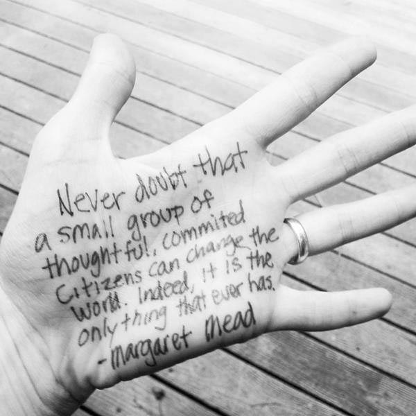 An inspirational quote written on a hand